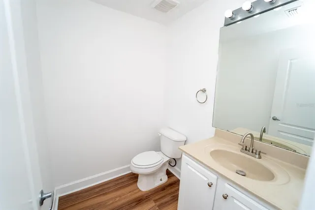 a bathroom with a sink toilet and vanity
