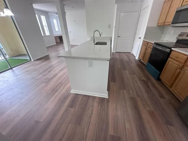 a view of a kitchen from a hallway