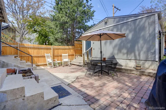 a view of backyard with wheel chair and potted plants