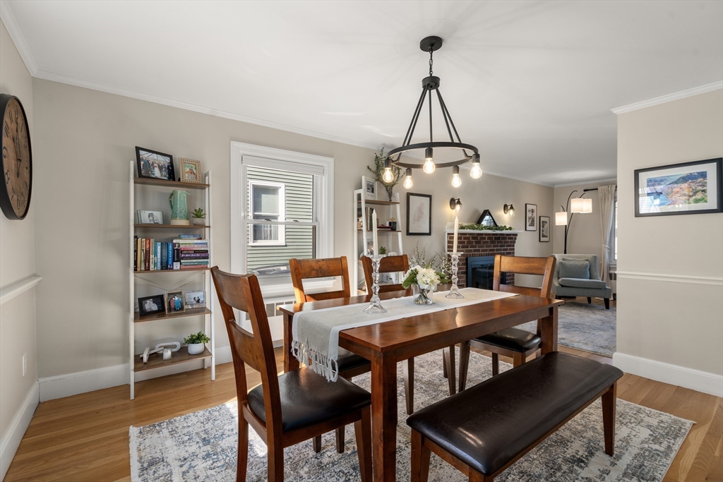 48 Spring Street Wakefield, MA 01880 - Photo 6 of 28 a view of a dining room and livingroom with furniture wooden floor a rug and a chandelier