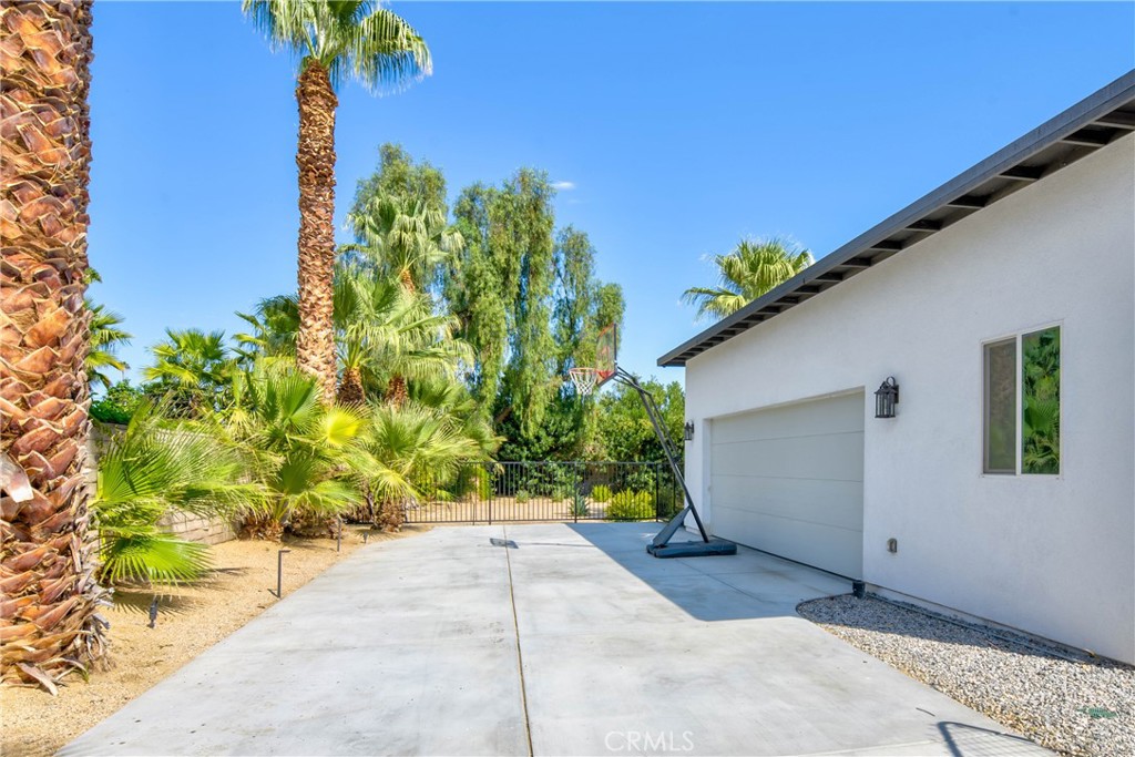72408 Desert Drive Rancho Mirage, CA 92270 - Photo 34 of 42 Basketball hoop and driveway to attached garage