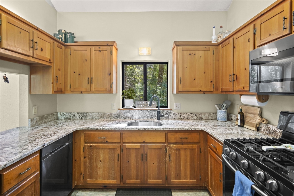 30 Harper Ridge Road Hampstead, NH 03826 - Photo 15 of 41 a kitchen with granite countertop a sink stove and cabinets