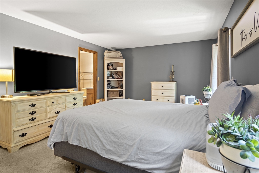 30 Harper Ridge Road Hampstead, NH 03826 - Photo 24 of 41 a bedroom with a bed and a flat screen tv
