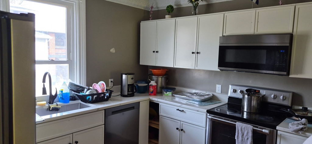 351 Bridge Street Northampton, MA 01060 - Photo 19 of 29 a kitchen with stainless steel appliances a sink a stove and cabinets