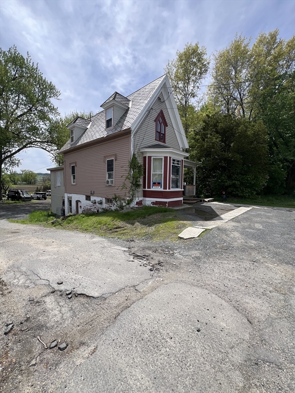 351 Bridge Street Northampton, MA 01060 - Photo 4 of 29 a front view of a house with a yard and garage
