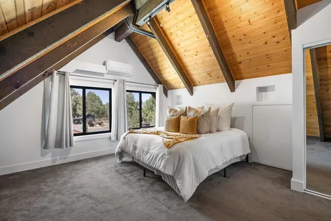 a bed room with a bed and a large window