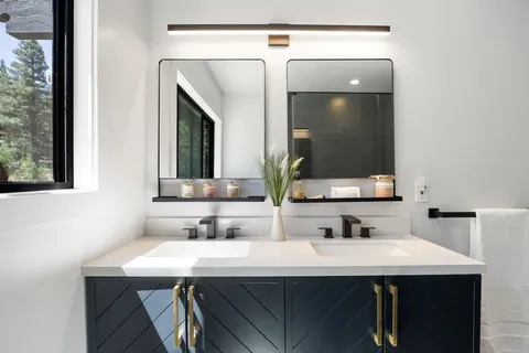 a bathroom with a sink a vanity and a mirror