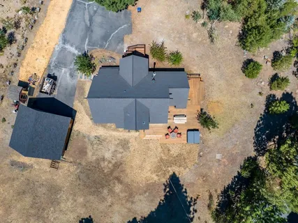 an aerial view of a house with a yard and garden