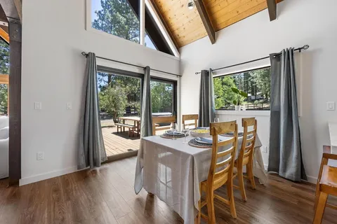 a dining room with furniture a chandelier and wooden floor