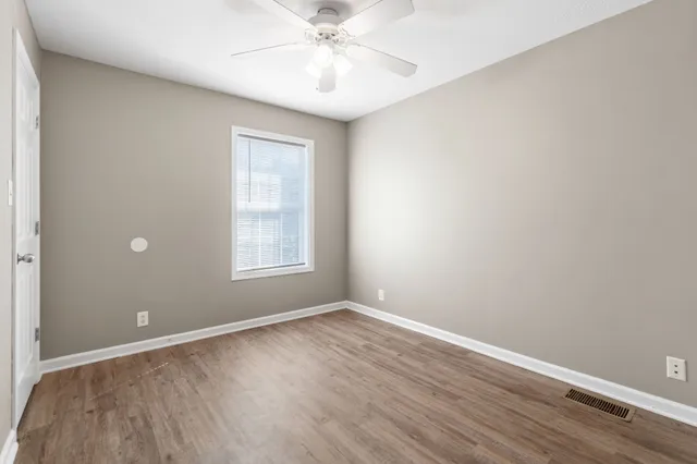 wooden floor in an empty room with a window