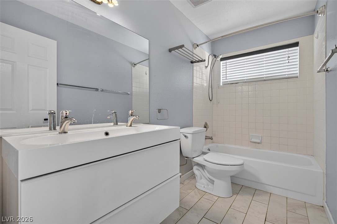 2609 Shakespeare Road Las Vegas, NV 89108 - Photo 27 of 41 A sleek white vanity with dual sinks highlights this functional and well-appointed bathroom.