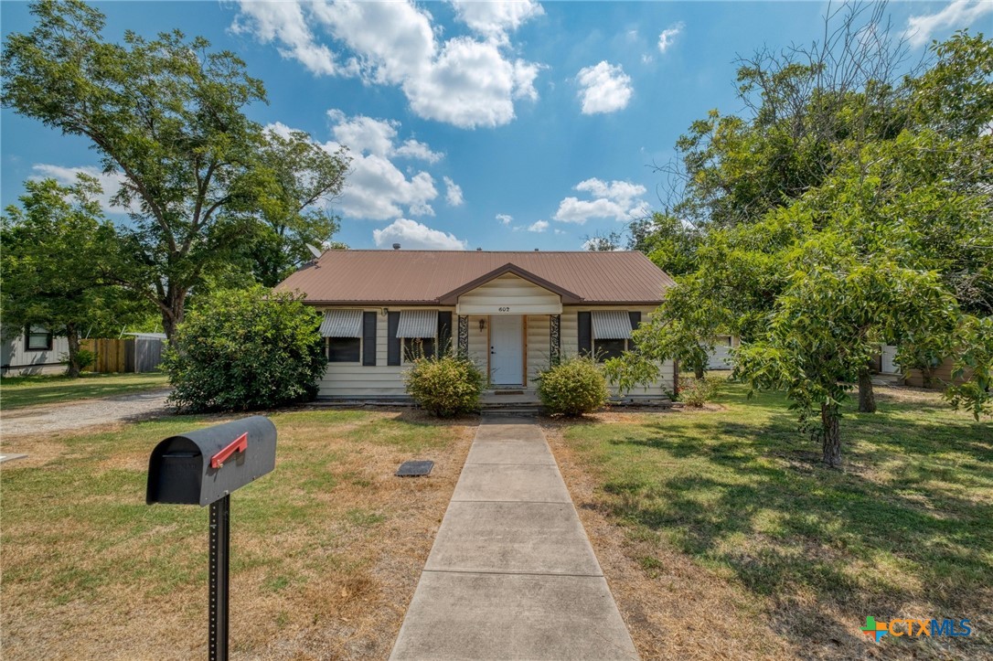 a front view of a house with yard