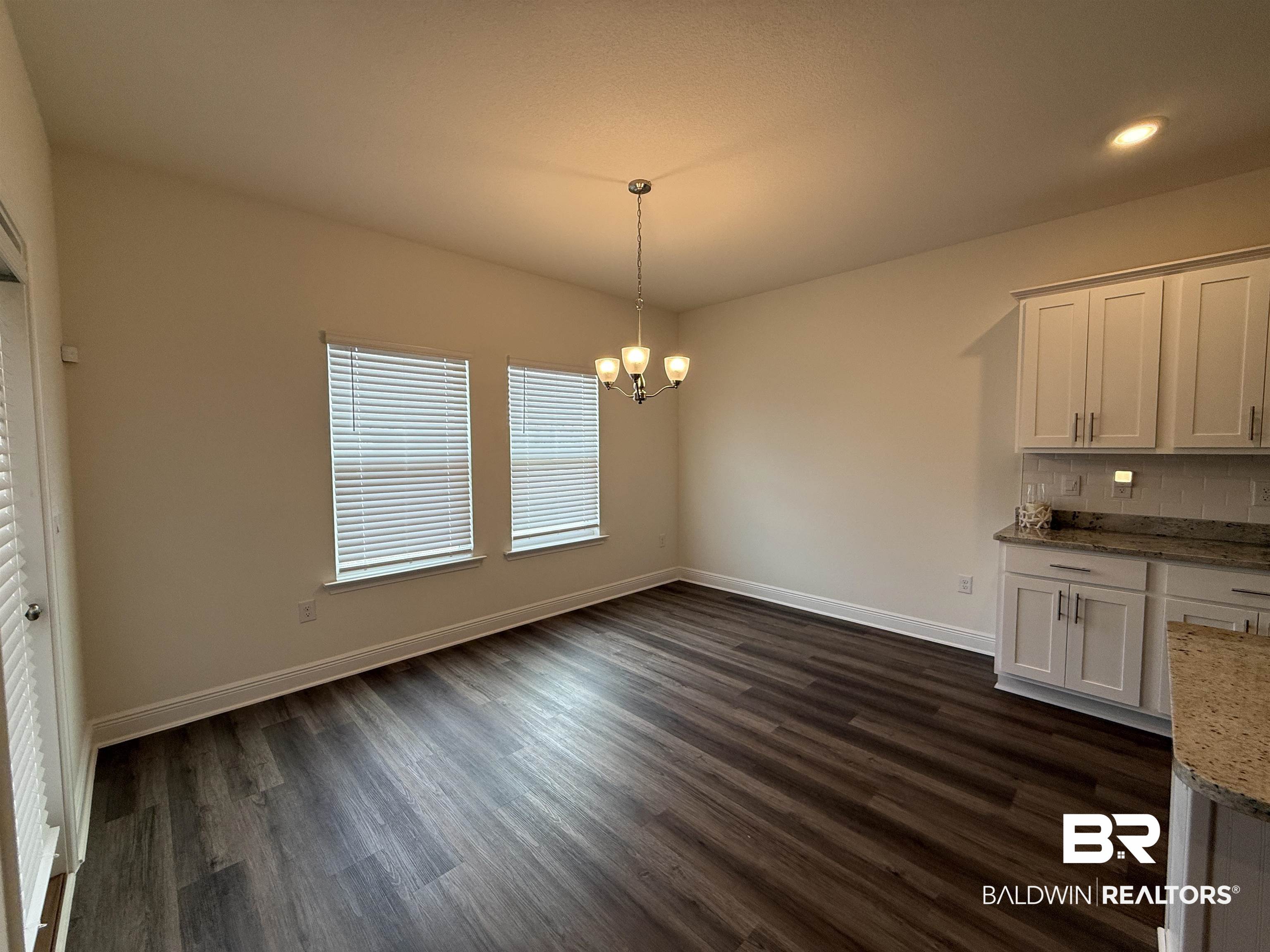 11442 Genuine Risk Circle Daphne, AL 36526 - Photo 5 of 21 Unfurnished dining area with suspended lighting and dark wood-type flooring
