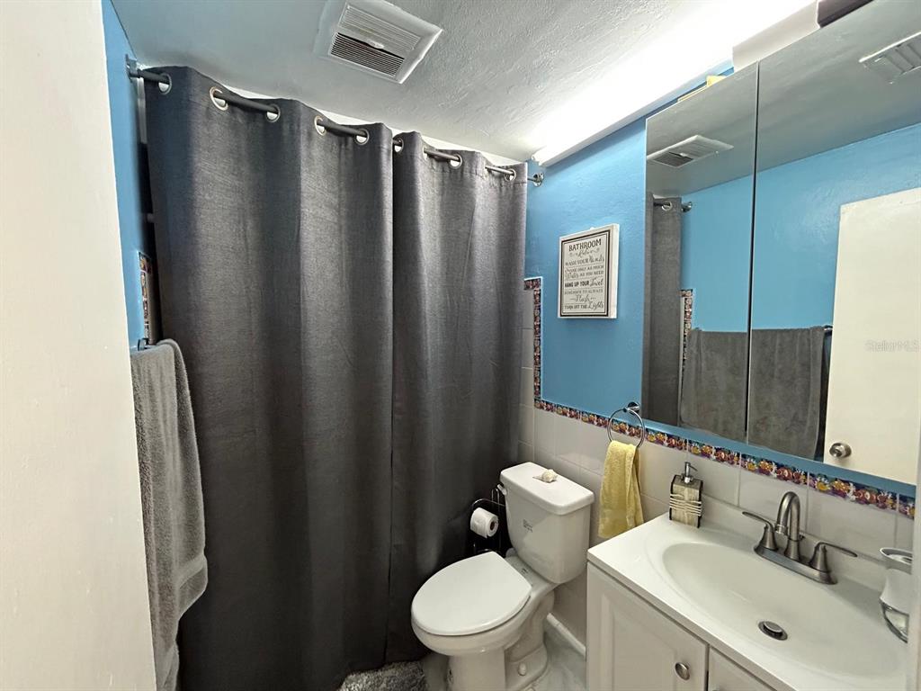 Undisclosed Address New Port Richey, FL 34652 - Photo 19 of 25 a bathroom with a sink toilet and shower