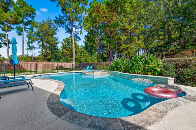 a view of a swimming pool with a patio