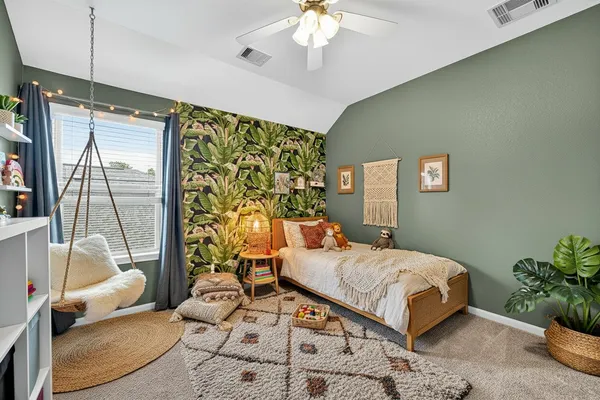 a bedroom with a large bed and a chandelier