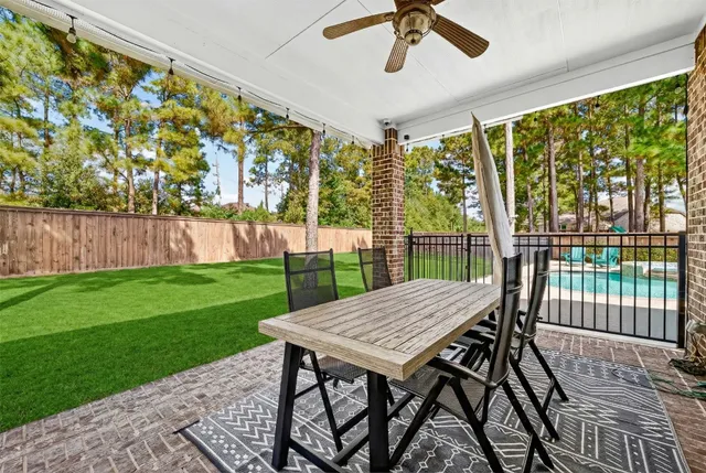 a view of a patio with a table chairs and a backyard