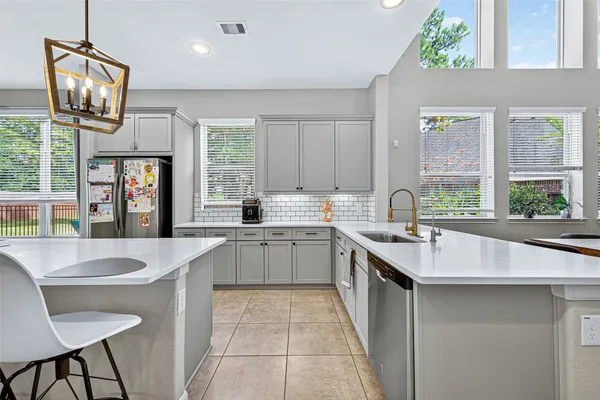 a large kitchen with kitchen island granite countertop a sink and a stove
