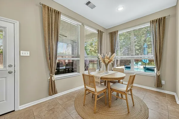 a dining room with furniture and window