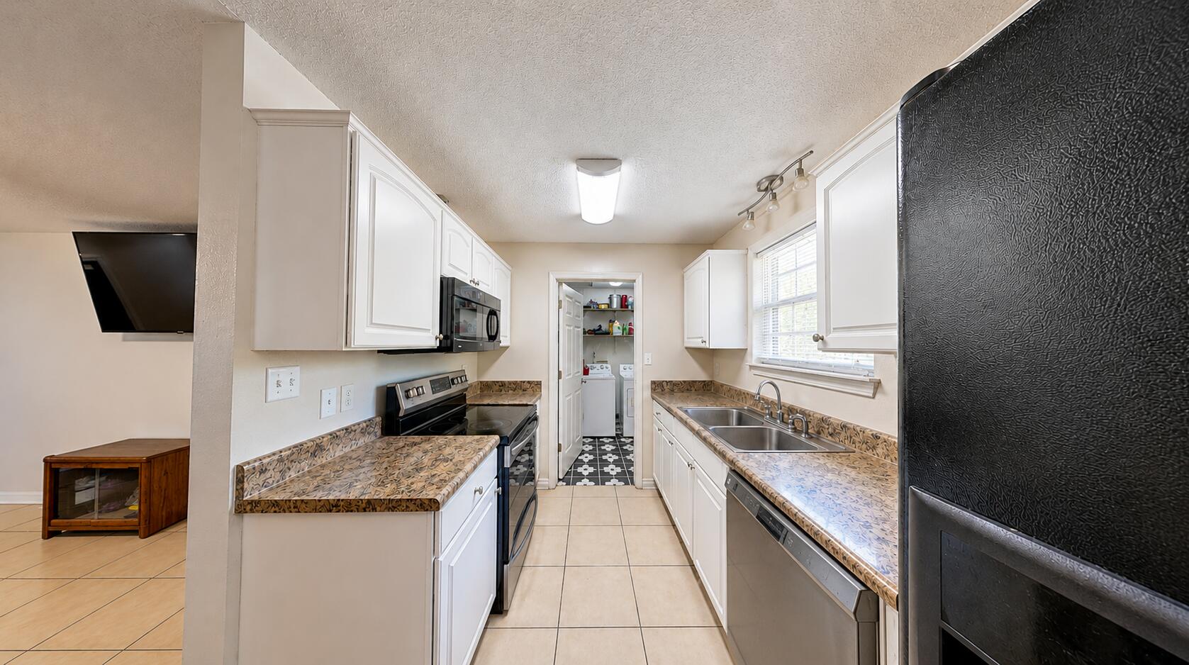 834 McDonald Street Crestview, FL 32536 - Photo 33 of 35 a kitchen with granite countertop stainless steel appliances and view living room