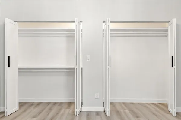 a view of walk in closet with empty racks