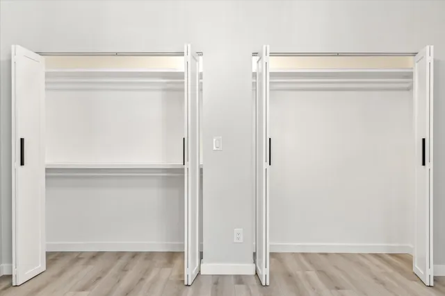 a view of walk in closet with empty racks