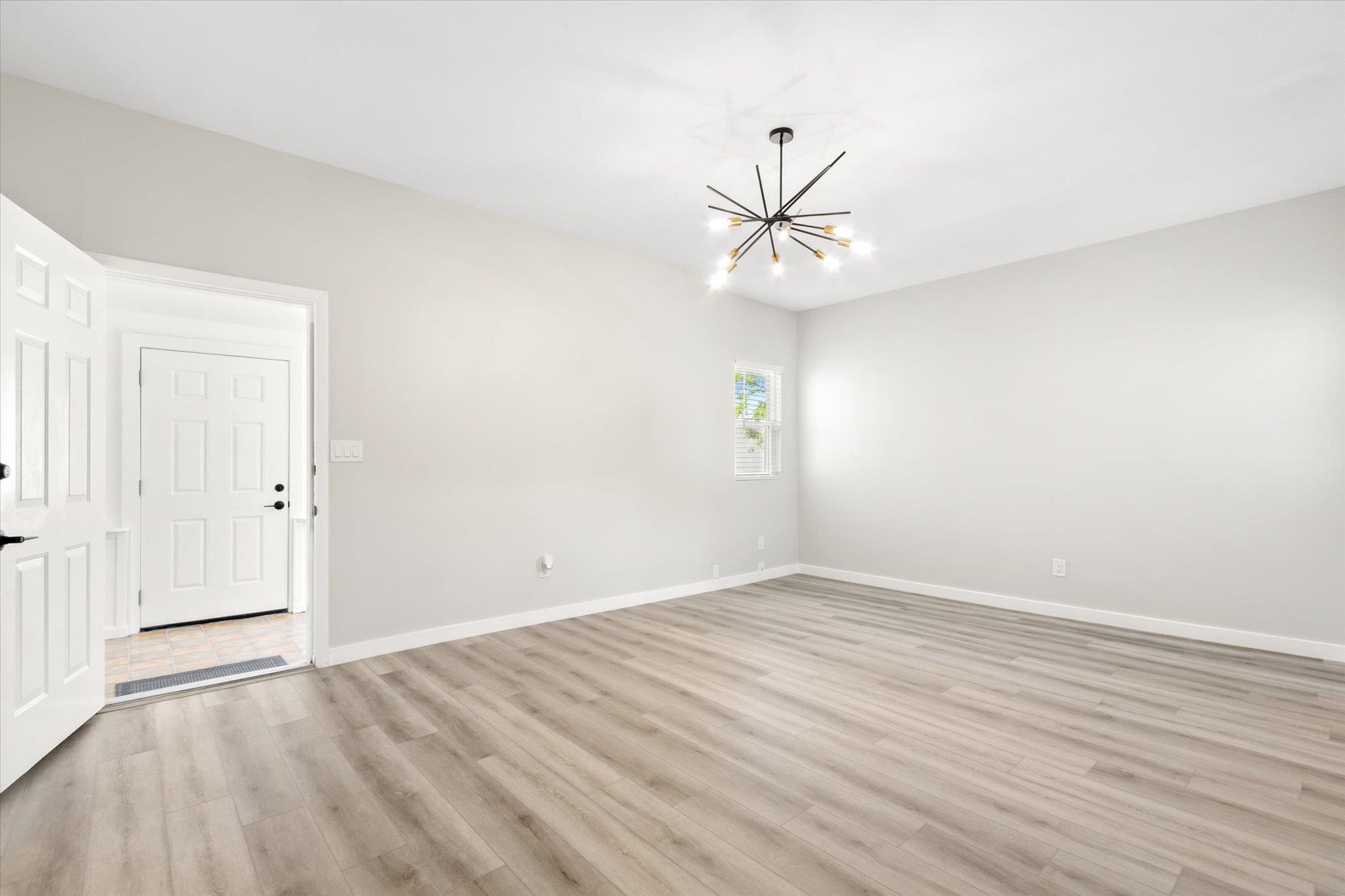28 Sebastian Avenue St. Augustine, FL 32084 - Photo 14 of 24 an empty room with wooden floor fan and windows