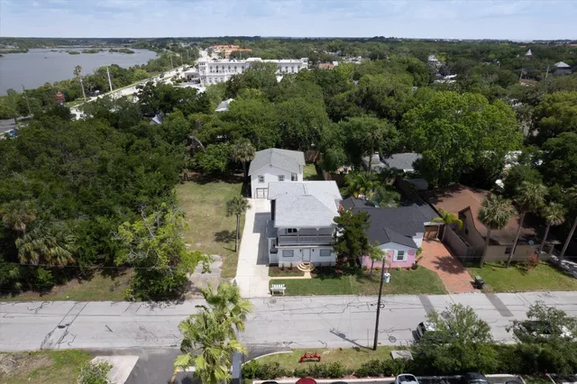 an aerial view of a house with a yard and lake view