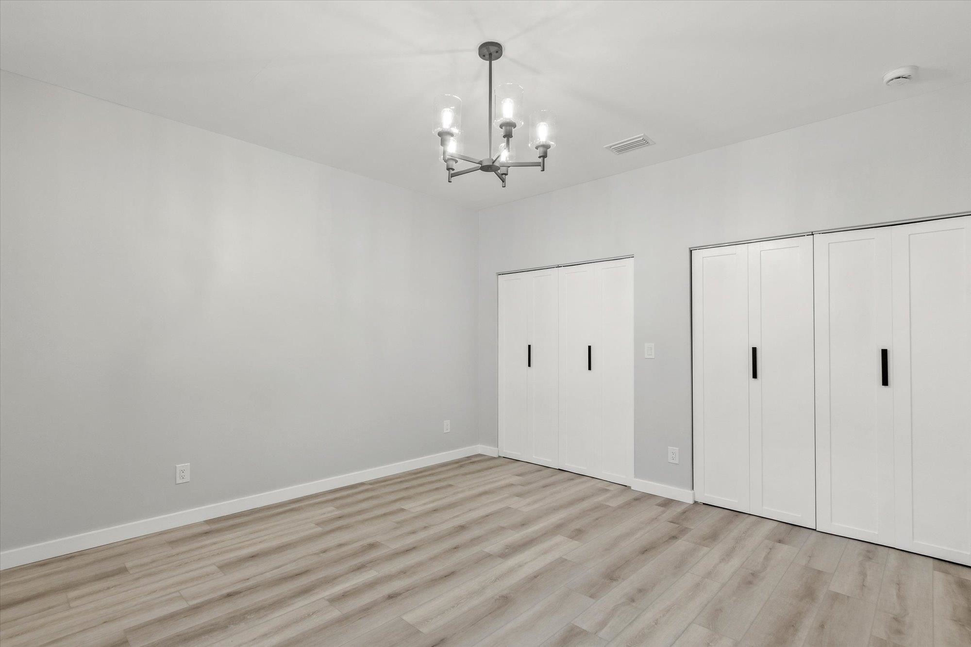 28 Sebastian Avenue St. Augustine, FL 32084 - Photo 10 of 24 wooden floor in an empty room with a window