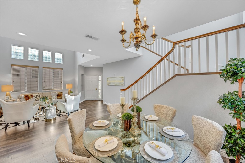 738 Orchard Loop Azusa, CA 91702 - Photo 11 of 50 a view of a dining room with furniture wooden floor and chandelier