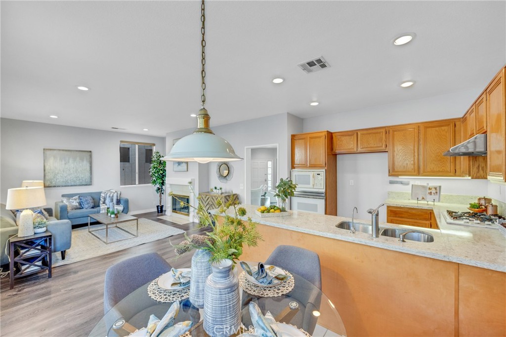 738 Orchard Loop Azusa, CA 91702 - Photo 19 of 50 a living room with furniture kitchen view and a chandelier