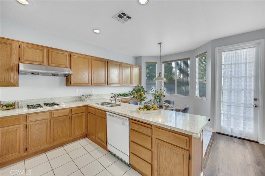 738 Orchard Loop Azusa, CA 91702 - Photo 24 of 50 a kitchen with a sink window and cabinets