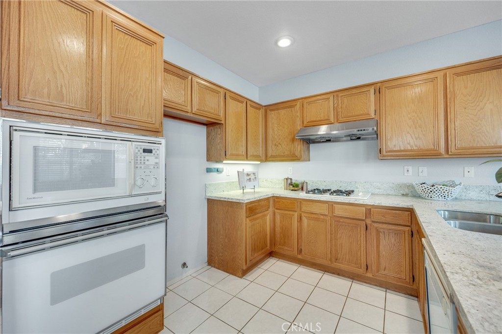 738 Orchard Loop Azusa, CA 91702 - Photo 25 of 50 a kitchen with granite countertop cabinets stainless steel appliances and a sink