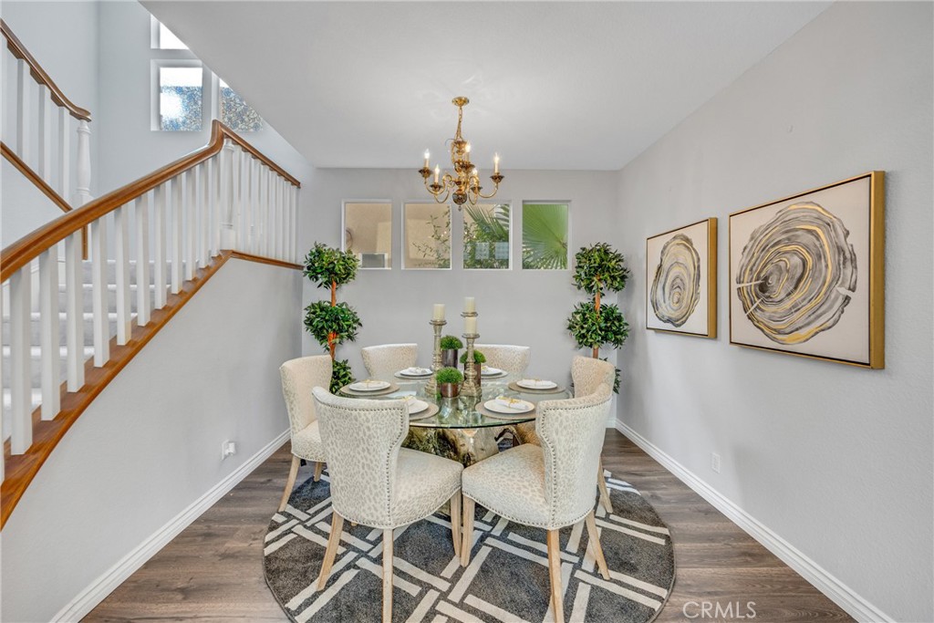 738 Orchard Loop Azusa, CA 91702 - Photo 10 of 50 a view of a dining room with furniture and a chandelier
