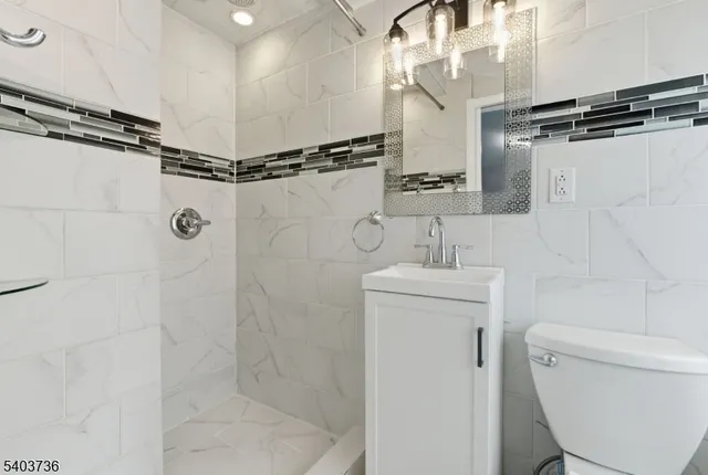 a bathroom with a shower a toilet and sink