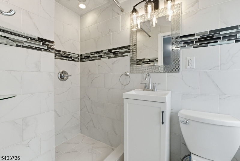 43 Freeman Street Woodbridge, NJ 07095 - Photo 13 of 24 a bathroom with a shower a toilet and sink