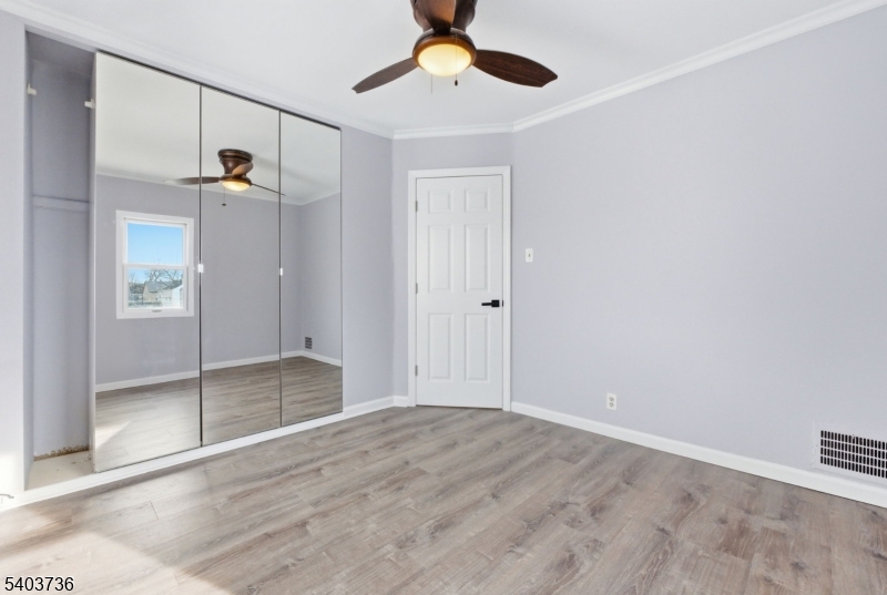 43 Freeman Street Woodbridge, NJ 07095 - Photo 18 of 24 a view of empty room with wooden floor and fan