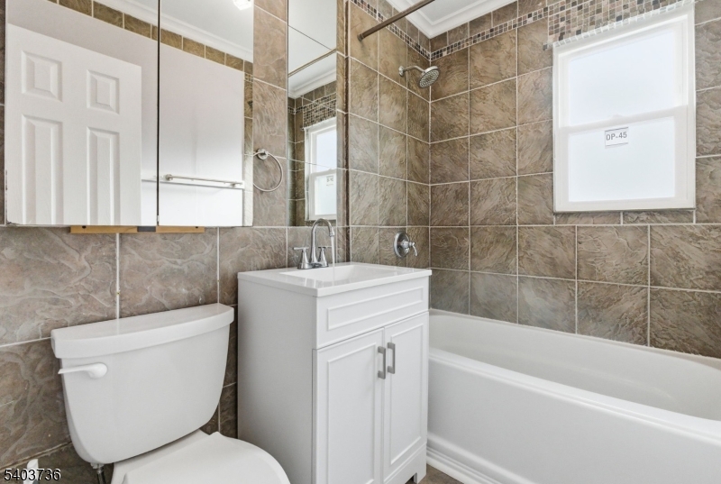 43 Freeman Street Woodbridge, NJ 07095 - Photo 19 of 24 a bathroom with a toilet sink and bathtub
