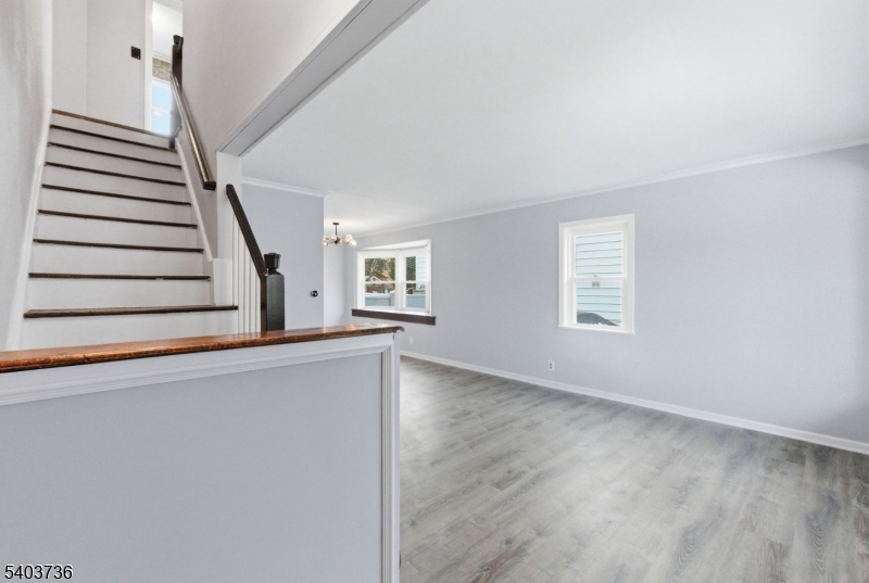 43 Freeman Street Woodbridge, NJ 07095 - Photo 4 of 24 a view of an empty room with wooden floor and a window