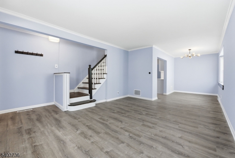 43 Freeman Street Woodbridge, NJ 07095 - Photo 5 of 24 a view of an empty room with wooden floor and stairs