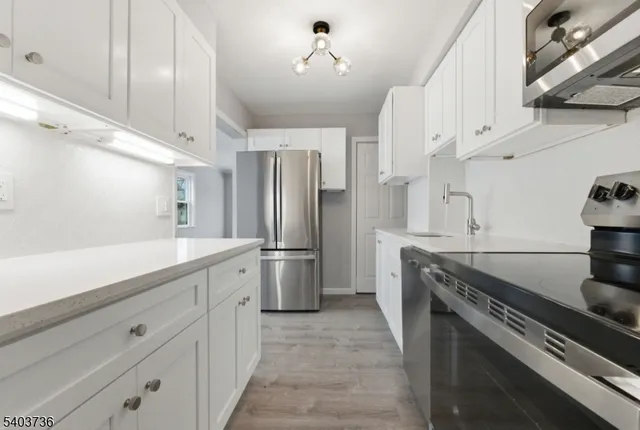 a kitchen with stainless steel appliances a stove and a refrigerator