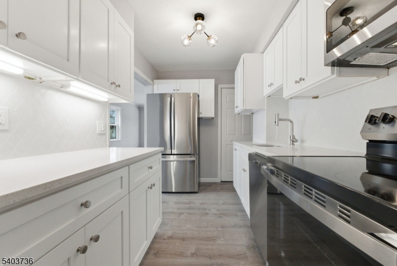 43 Freeman Street Woodbridge, NJ 07095 - Photo 10 of 24 a kitchen with stainless steel appliances a stove and a refrigerator
