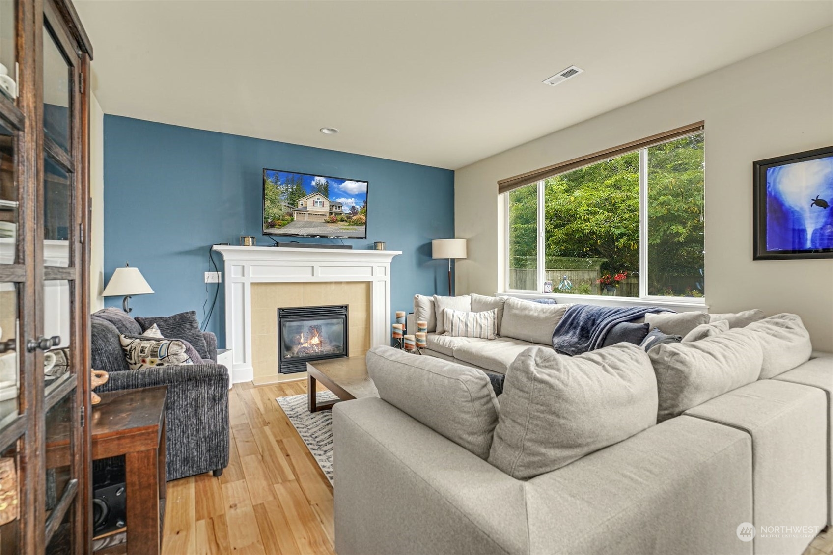 4029 180th Place Southeast Bothell, WA 98012 - Photo 12 of 33 a living room with furniture a fireplace and a large window