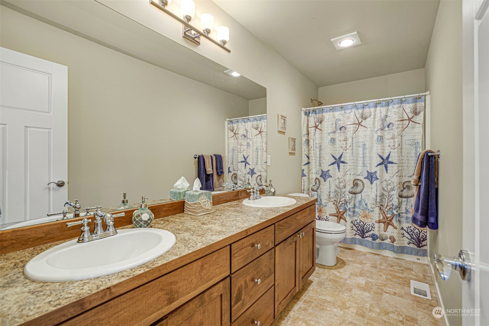 4029 180th Place Southeast Bothell, WA 98012 - Photo 27 of 33 a bathroom with double vanity sinks a shower and a mirror