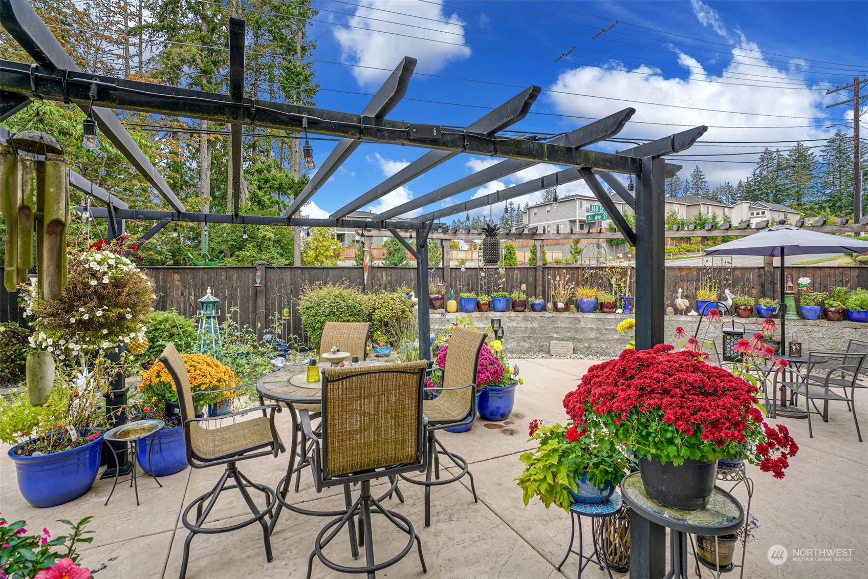 4029 180th Place Southeast Bothell, WA 98012 - Photo 30 of 33 a patio with a table and chairs and potted plants