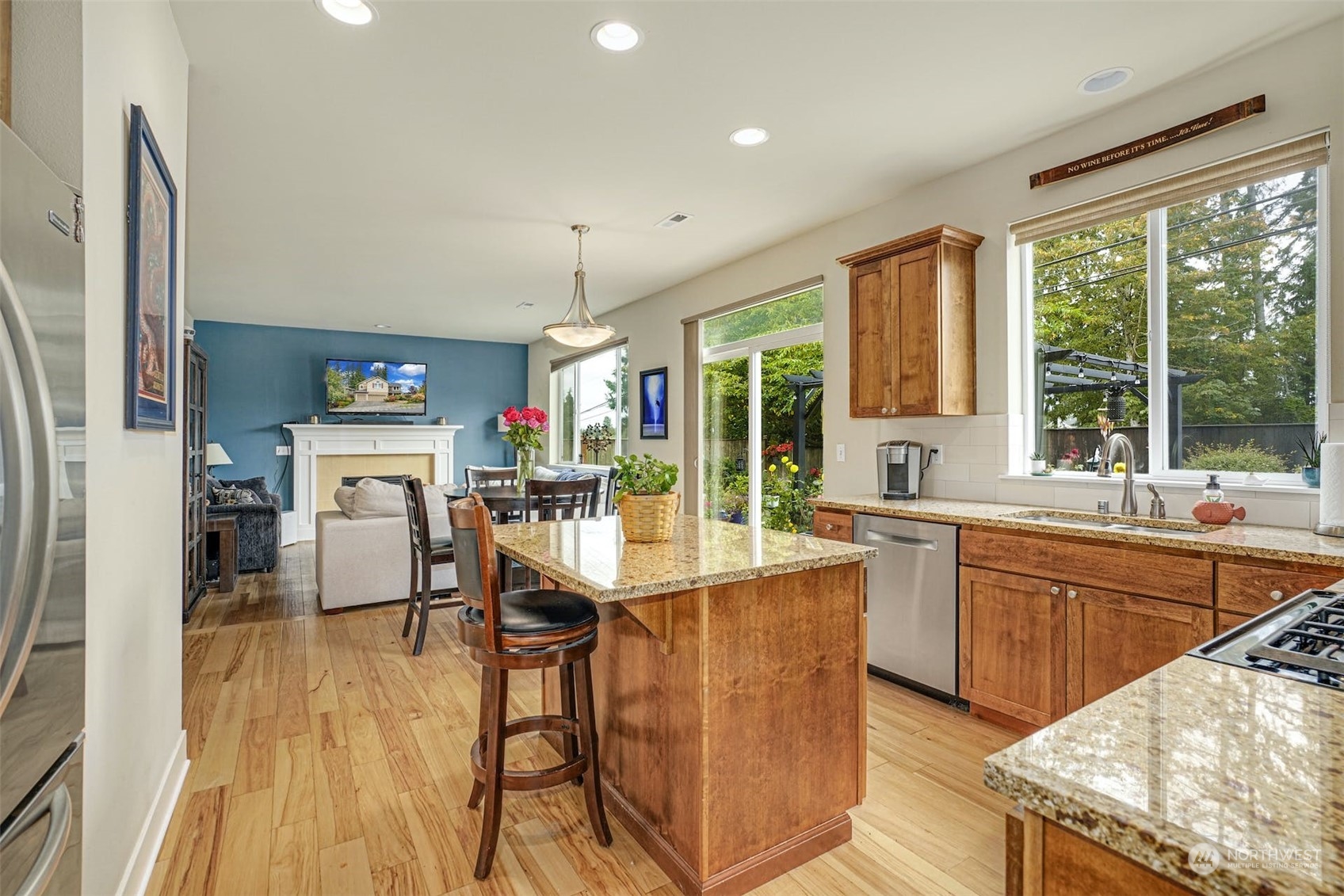 4029 180th Place Southeast Bothell, WA 98012 - Photo 8 of 33 a kitchen with stainless steel appliances granite countertop dining table chairs sink and wooden floor