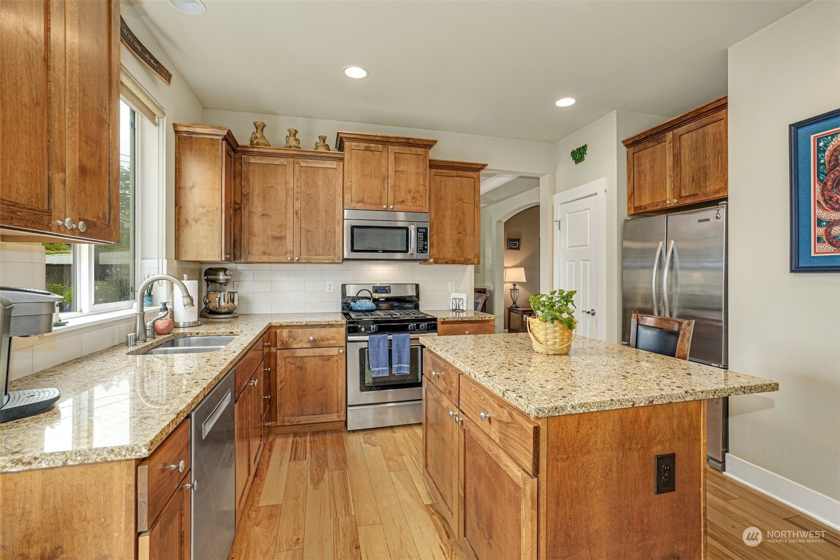 4029 180th Place Southeast Bothell, WA 98012 - Photo 9 of 33 a kitchen with stainless steel appliances granite countertop a sink stove microwave and refrigerator