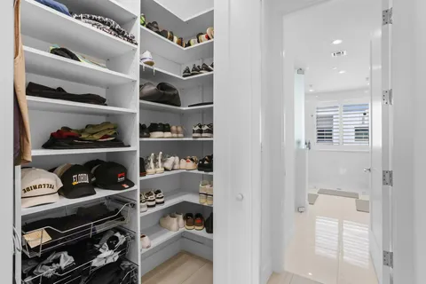 a bathroom with a double vanity sink mirror and shower