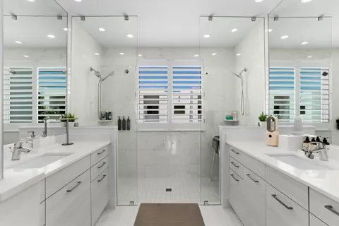 a spacious bathroom with a granite countertop sink mirror and double
