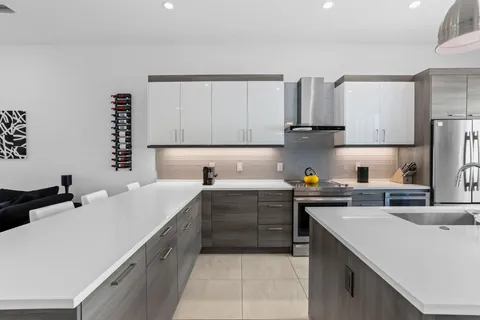 a kitchen with sink and refrigerator